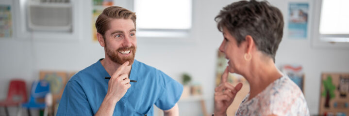 Speech therapist helping senior patient